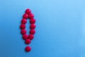 Pink pills lined up with an exclamation mark Royalty Free Stock Photo