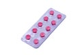 Pink pills in a package isolated on a white background Royalty Free Stock Photo