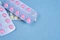 pink pills in packs vitamins pain reliever blue background Royalty Free Stock Photo