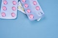 pink pills in packs vitamins pain reliever blue background Royalty Free Stock Photo