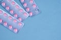 pink pills in packs vitamins pain reliever blue background Royalty Free Stock Photo