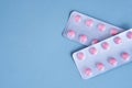 pink pills in packs vitamins pain reliever blue background Royalty Free Stock Photo