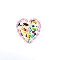 Pink pills in the shape of a heart on a white isolated background. One-to-one square shot for social networks. Heart Royalty Free Stock Photo