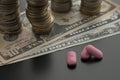 Pink pills, tablets, drugs with dollar bills Royalty Free Stock Photo