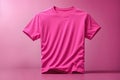 Pink plain shortsleeve cotton T-Shirt isolated on a pink background. Stylish round collar shirt