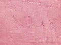 Pink plastered concrete wall texture, painted built structure of grungy uneven painted plaster. Abstract pink background