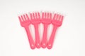 Pink plastic baby fork on a white background isolated