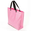 A pink plastic bag with a black handle isolated on white background Royalty Free Stock Photo