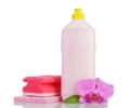 Pink plastic bottle with cleaner, household sponge and orchid isolated.