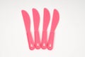 Pink plastic children knives on a white background Royalty Free Stock Photo