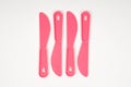 Pink plastic children knives on a white background Royalty Free Stock Photo