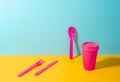 Pink plastic cutlery set and paper coffee cup Royalty Free Stock Photo