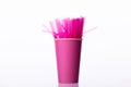 Pink plastic flexible straws in paper cup, isolated white background. Hen party