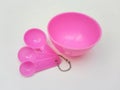 Pink Plastic Measuring Spoons Set with Mixing Bowl Isolated on White Background Royalty Free Stock Photo