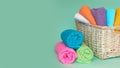 Pink plastic measuring vessel with washing powder, containers with detergent, stack terry towels Royalty Free Stock Photo