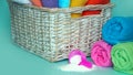 Pink plastic measuring vessel with washing powder, containers with detergent, stack terry towels