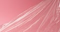 Pink Plastic Sheet Draped Over Surface in Soft Lighting Royalty Free Stock Photo