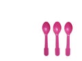 Pink plastic spoons isolated on white