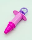 Pink plastic syringe of doctor and nurse play set Royalty Free Stock Photo