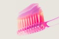 Pink plastic toothbrush with strawberry toothpaste on an isolated background Royalty Free Stock Photo