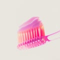Pink plastic toothbrush with strawberry toothpaste on an isolated background Royalty Free Stock Photo