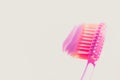 Pink plastic toothbrush with strawberry toothpaste on white isolated background. Side view Royalty Free Stock Photo