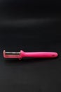 Used plastic vegetable peeler with a rusty knife on a black background Royalty Free Stock Photo