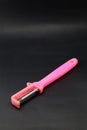 Used plastic vegetable peeler with a rusty knife on a black background Royalty Free Stock Photo