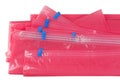 Pink plastic zip lock bag with blue sealing to pack store cloths