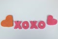 Pink plasticine and clay letters spelling xoxo hugs and kisses w Royalty Free Stock Photo