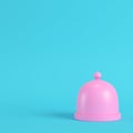 Pink plate with dome on bright blue background in pastel colors