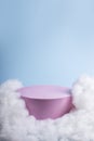 Pink podium with cloud on pastel blue background