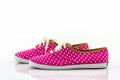 Pink polka dot canvas shoe.