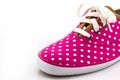 Pink polka dot canvas shoe.