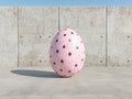 Pink polka dot Easter egg on a concrete background Royalty Free Stock Photo