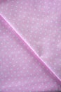 Pink polka dot fabric sample. Fabric background