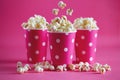 Pink polka dot paper cups with tasty popcorn.