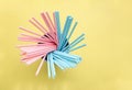 Pink polka dot paper straws and light blue polka dot paper straws on yellow background. Drinking straws Royalty Free Stock Photo