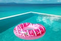 Pink Pool float. Big inflatable donut in infinity swimming pool.