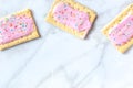 Pink pop tarts, shot from the top on a white marble background Royalty Free Stock Photo
