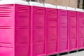 Pink portable female toilets in a row in the city