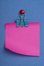 Pink postit on blue Royalty Free Stock Photo