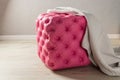 Pink pouf, furniture with decoration buttons with a gray blanket Royalty Free Stock Photo