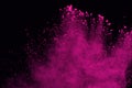 Pink powder explosion on black background. Colored cloud. Colorful dust explode. Paint Holi. Royalty Free Stock Photo