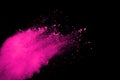 Pink powder explosion on black background. Colored cloud. Colorful dust explode. Paint Holi