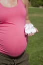Pink pregnant with bootees in hand Royalty Free Stock Photo
