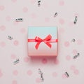 Pink present box on pink konfetti background. Royalty Free Stock Photo