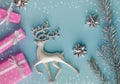 Pink presents or gifts in Christmas composition on blue background.