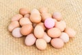 Pink preserved egg on fresh eggs Royalty Free Stock Photo