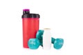 Pink protein blender bottle with a pair of blue fitness dumbbells and protein drink. Royalty Free Stock Photo